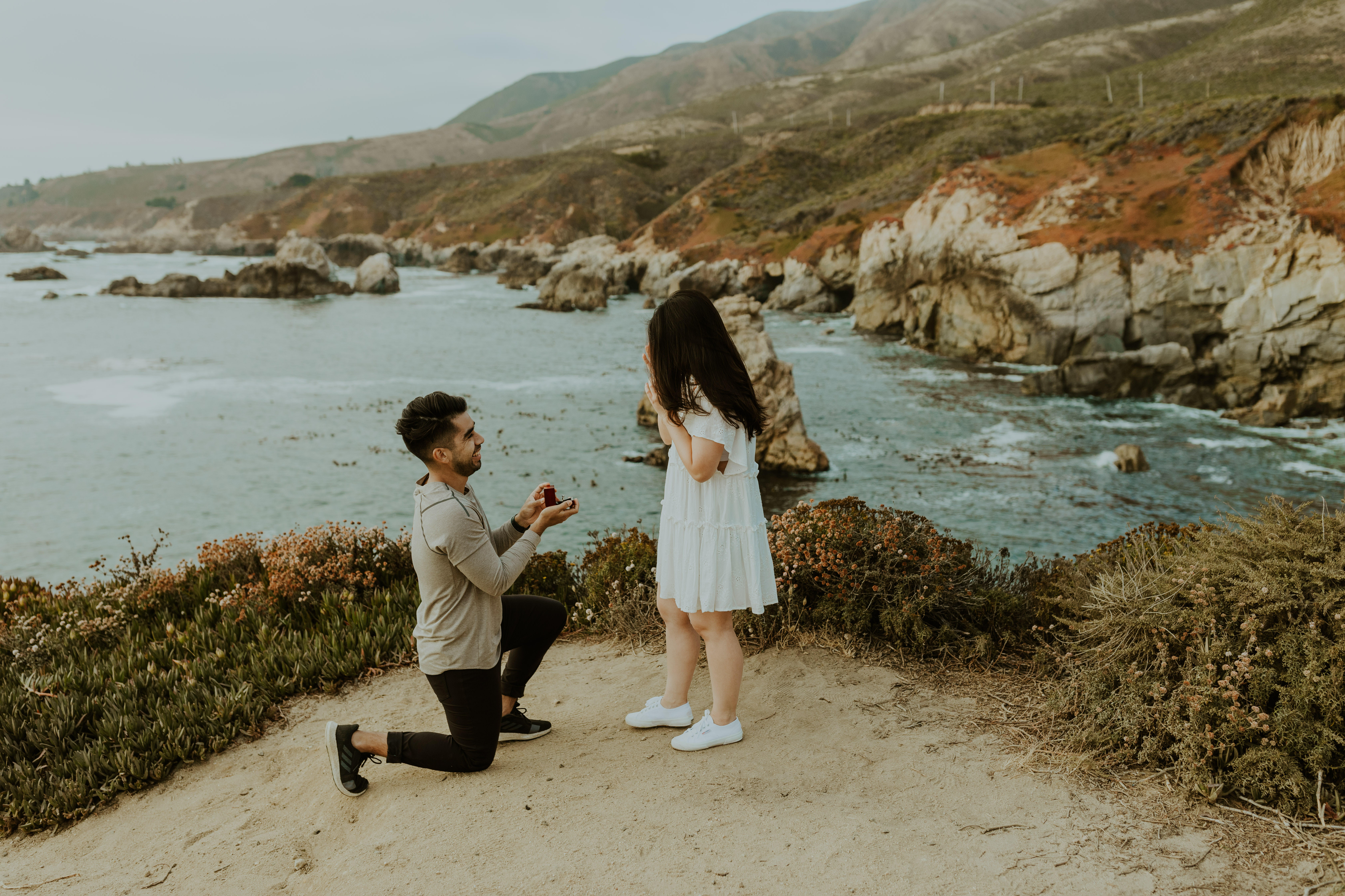 Big Sur Proposal - man on one knee with ring proposing to his girlfriend.