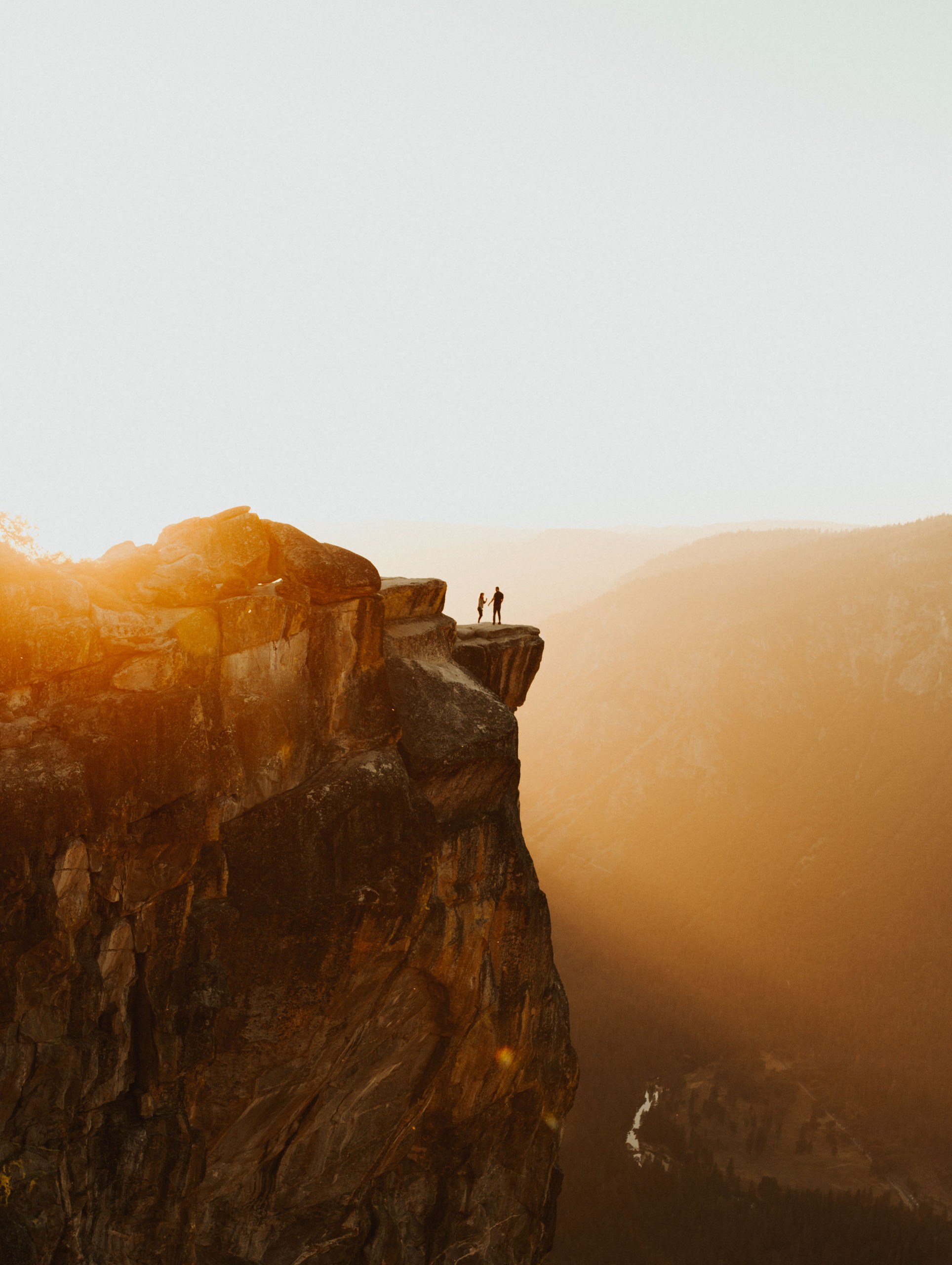 couple standing on taft point at sunset