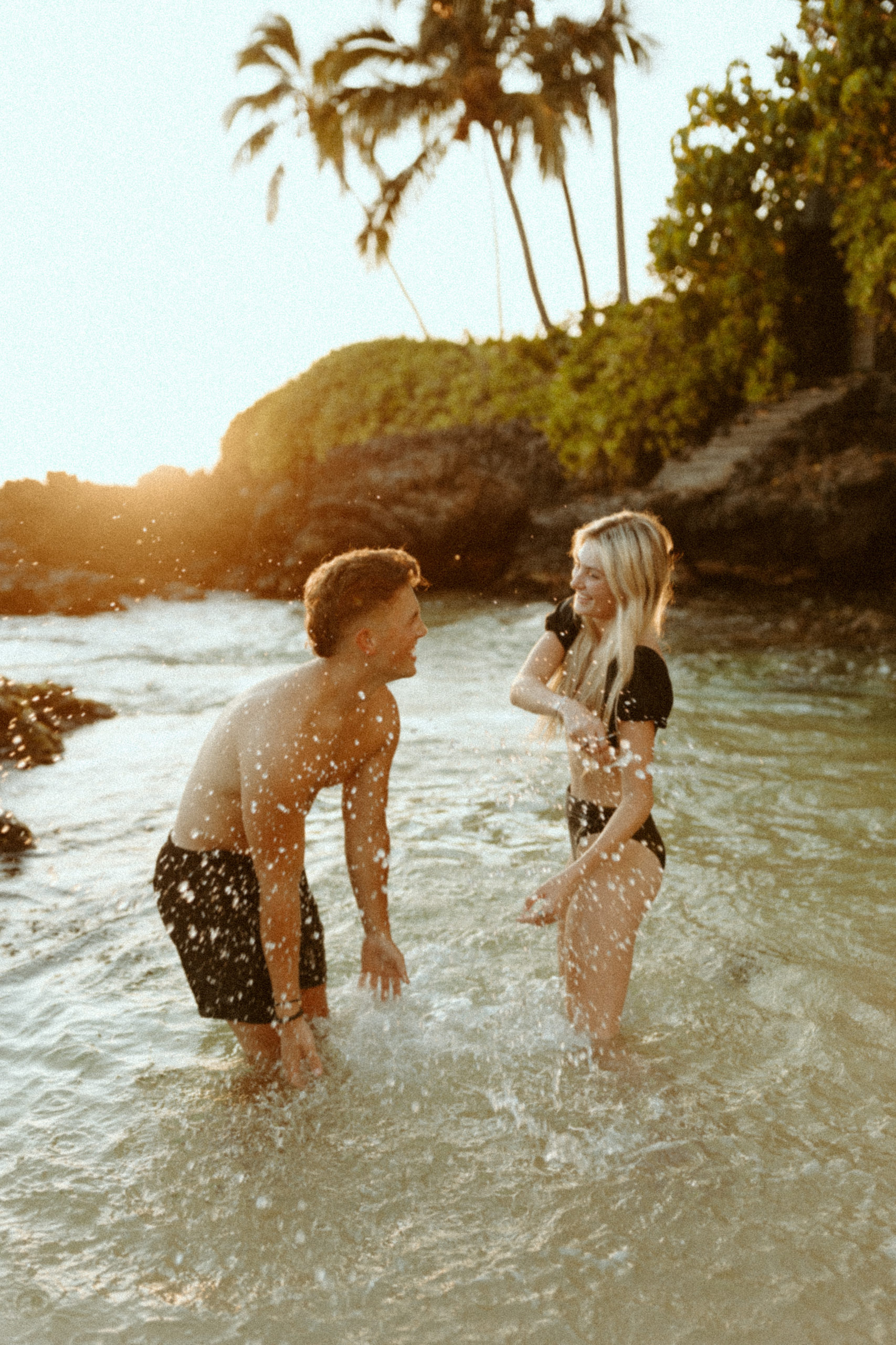 couple playing in the water together in Maui