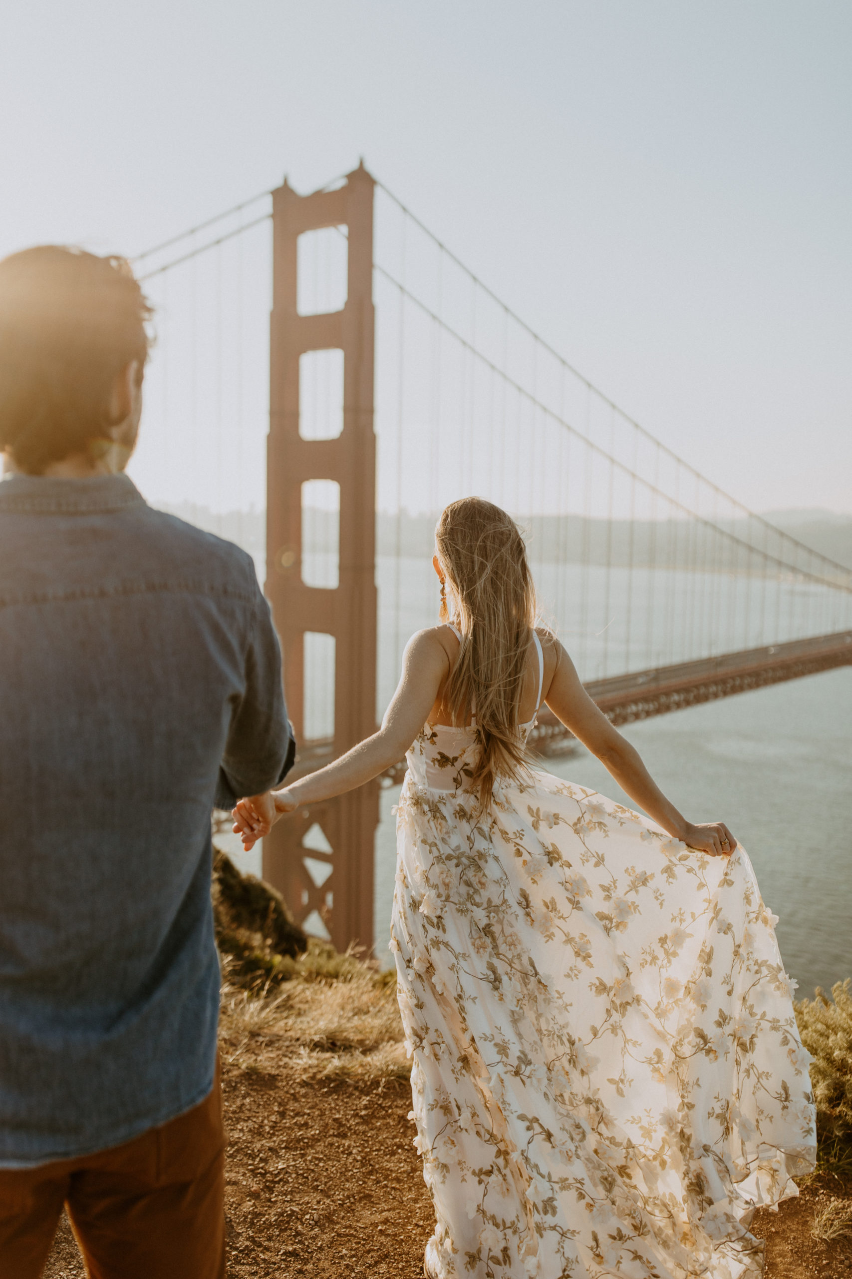 the couple twirling in the sunrise at the Golden Gate Bridge in San Francisco