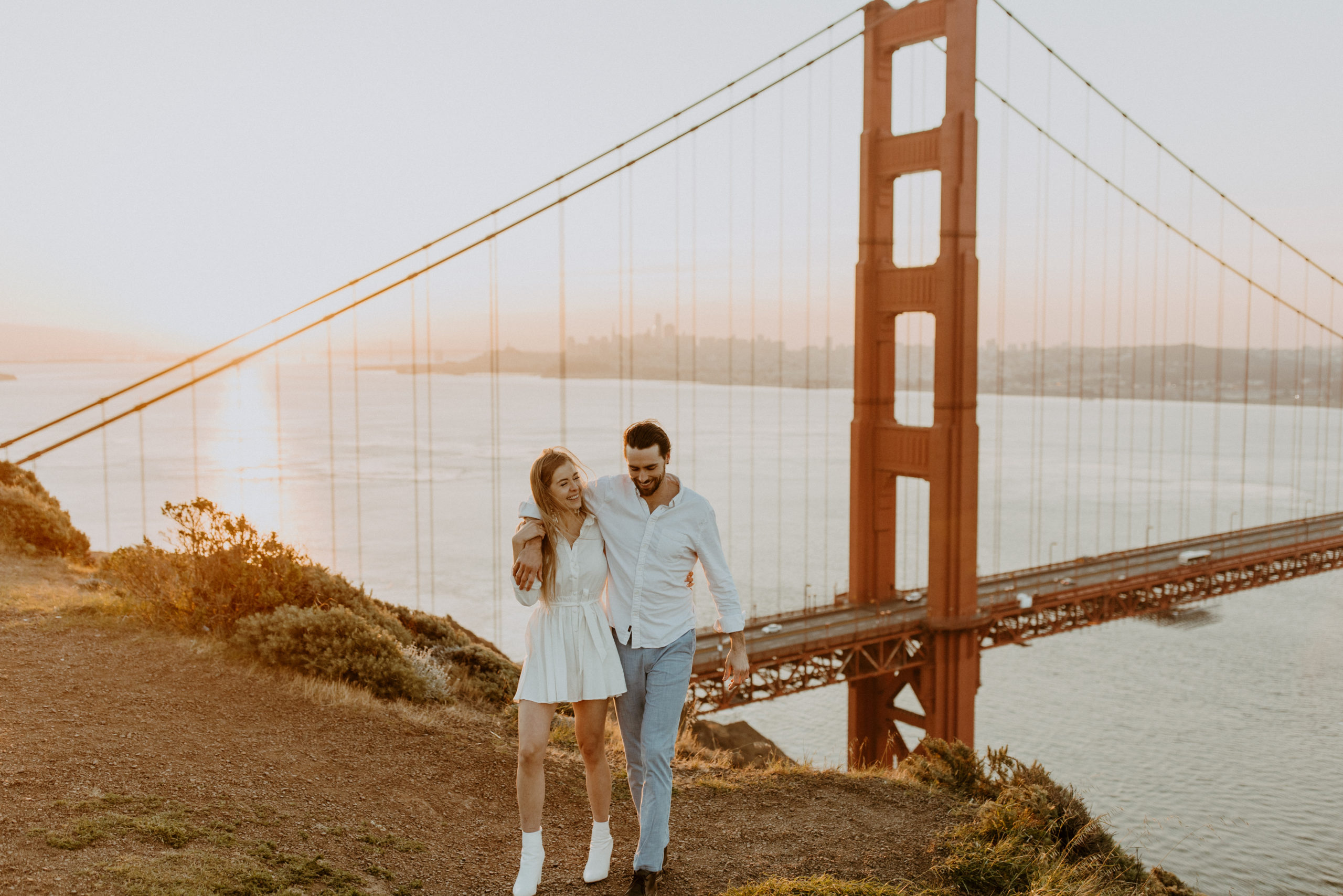 the couple walking away from the Golden Gate Bridge
