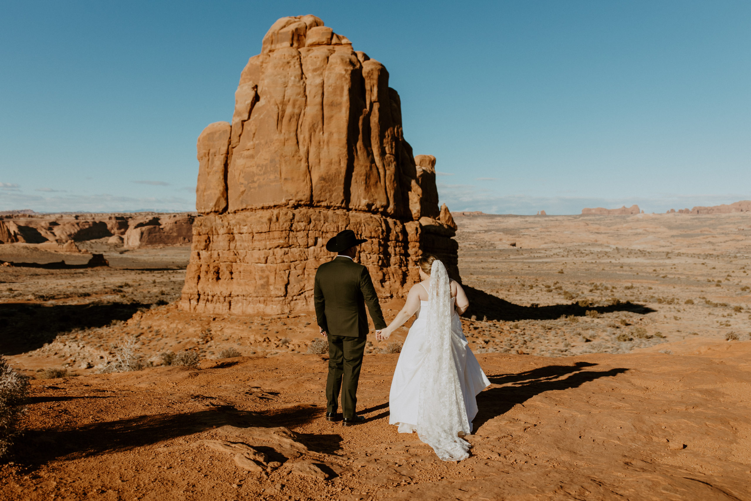the couple walking away from the elopement photographer