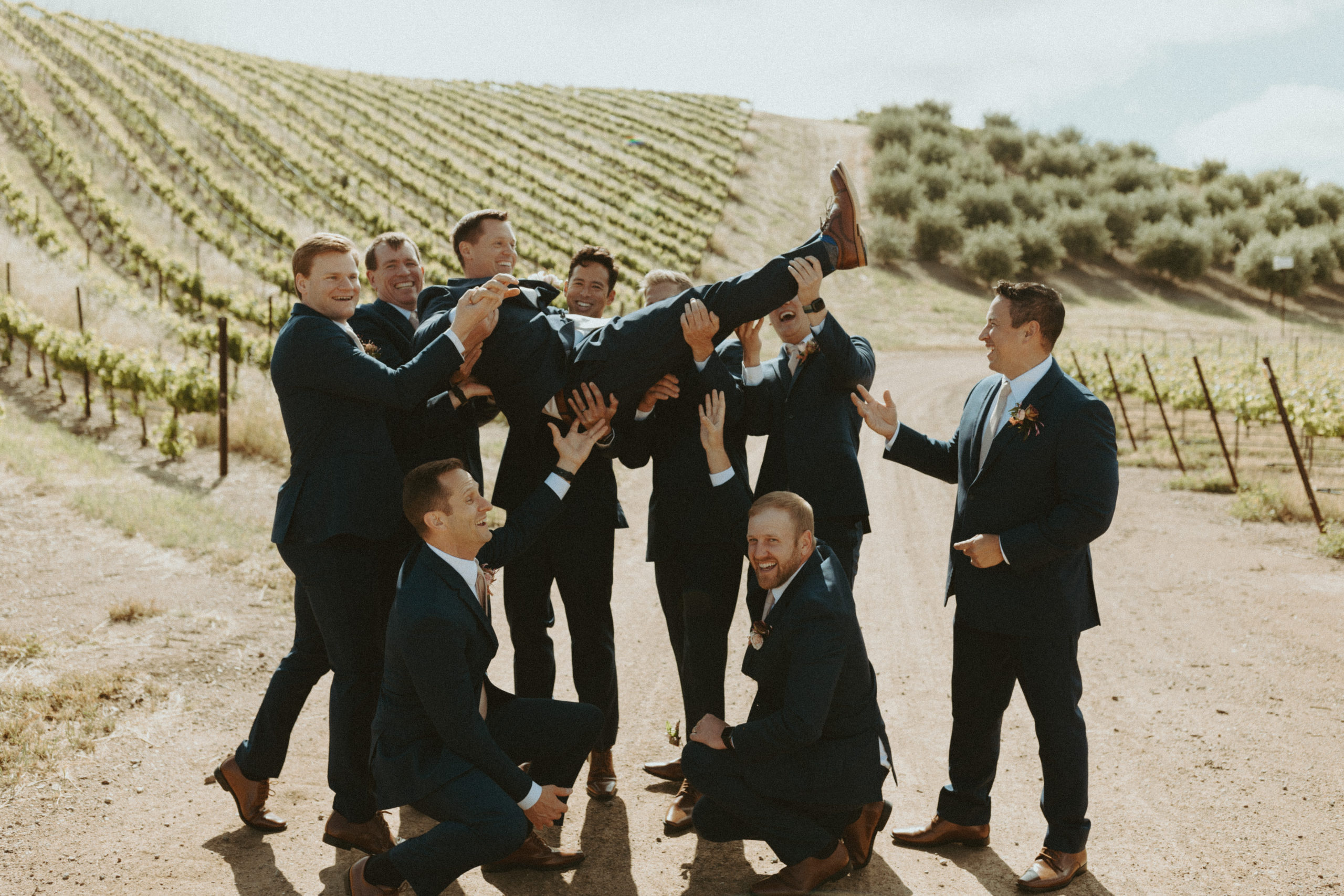 the groomsmen enjoying the vineyard