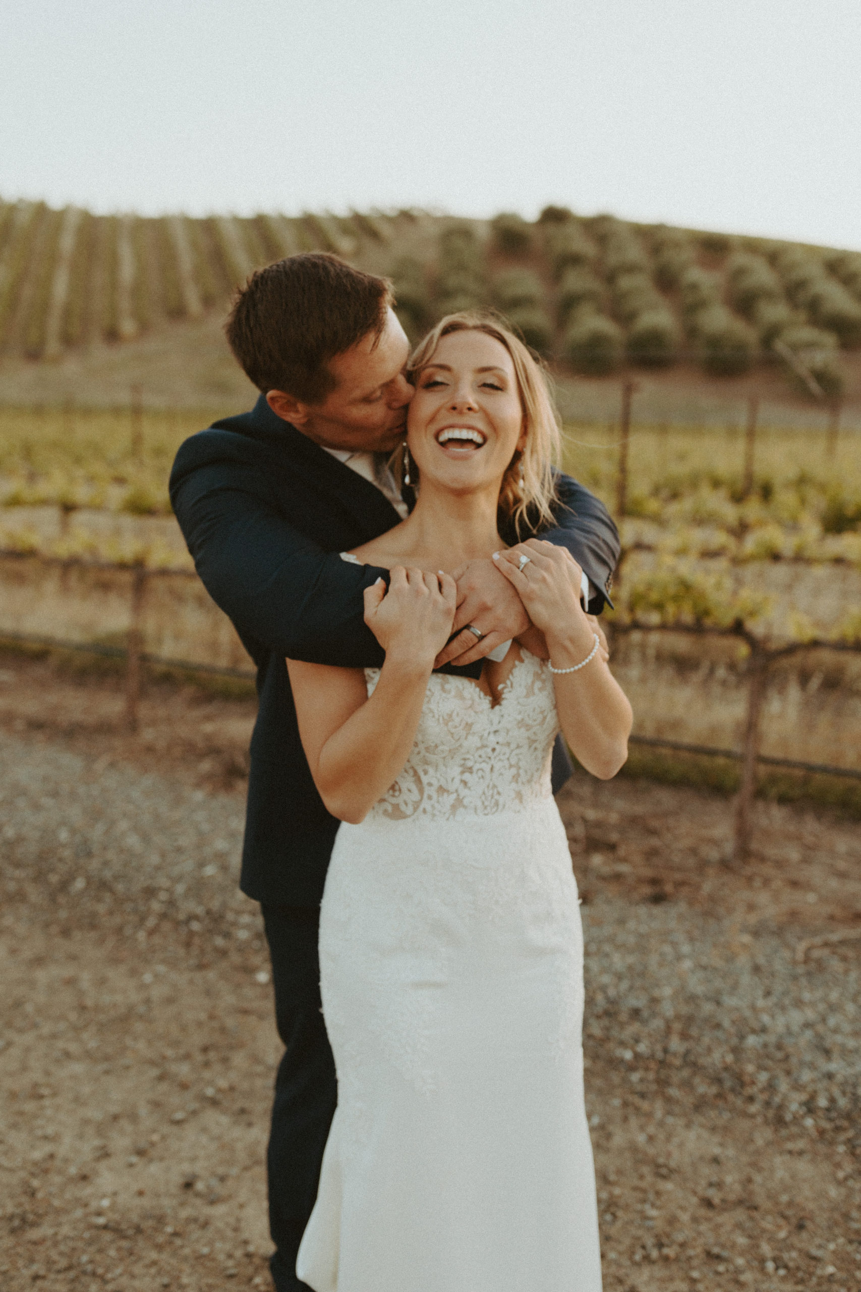 the bride laughing with the groom at the vineyard in California