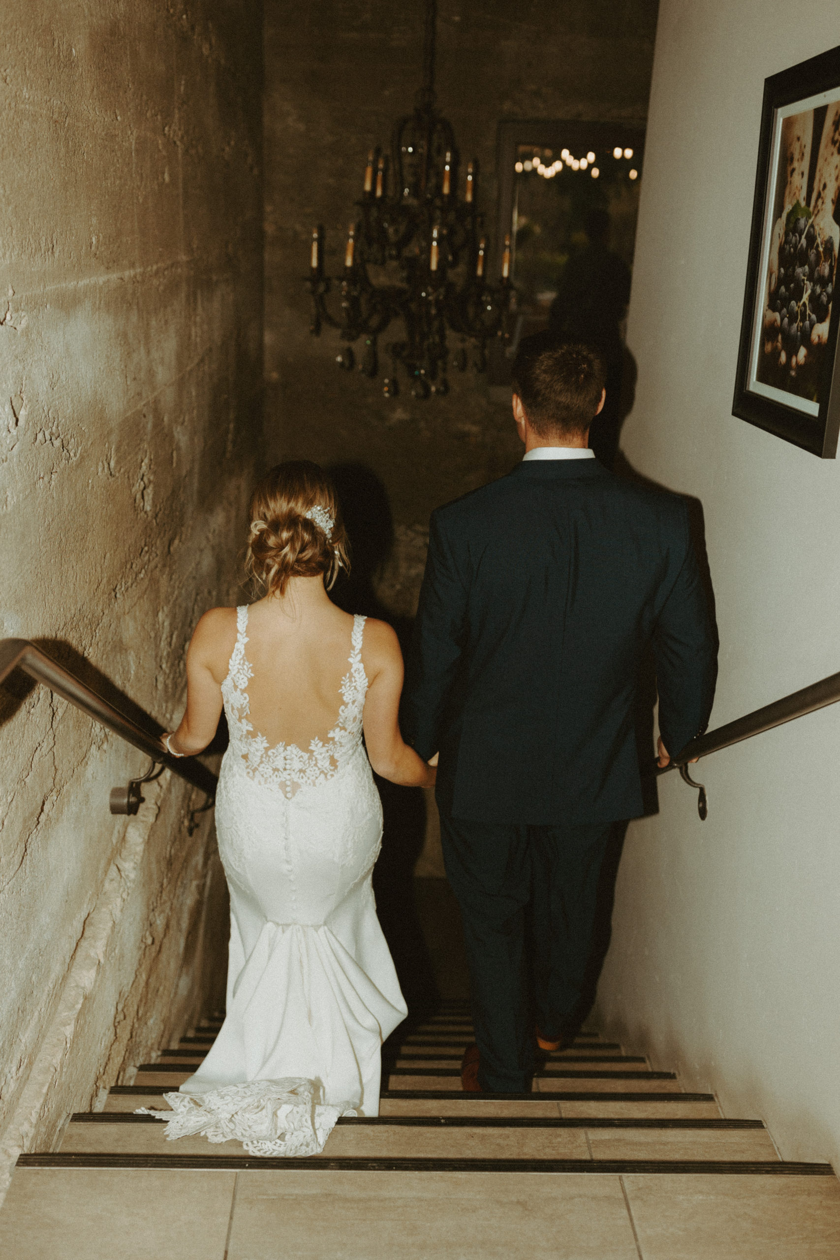 the couple walking down the stairs at their vineyard in California