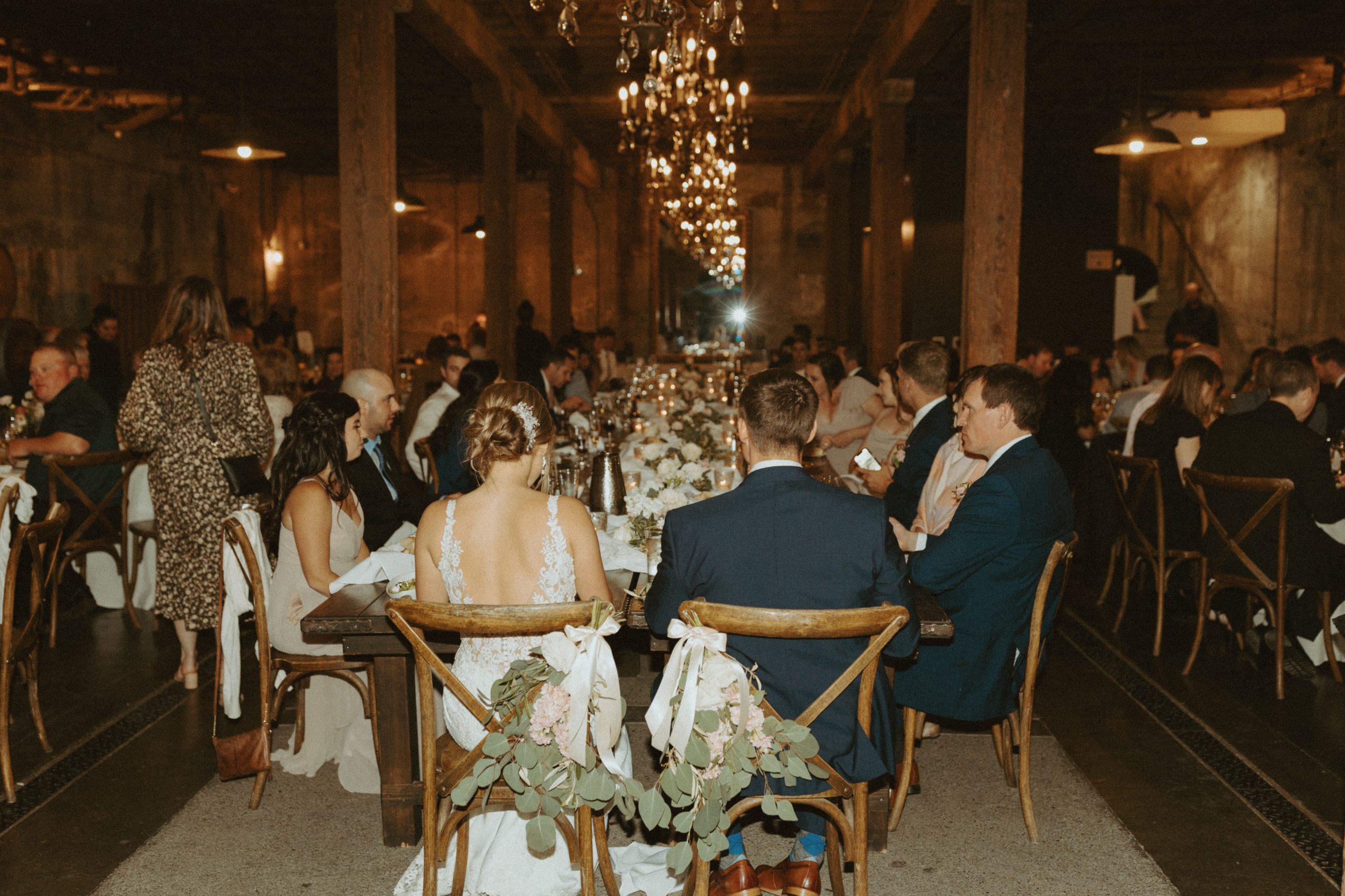 the couple sitting and enjoying their reception at their venue in California