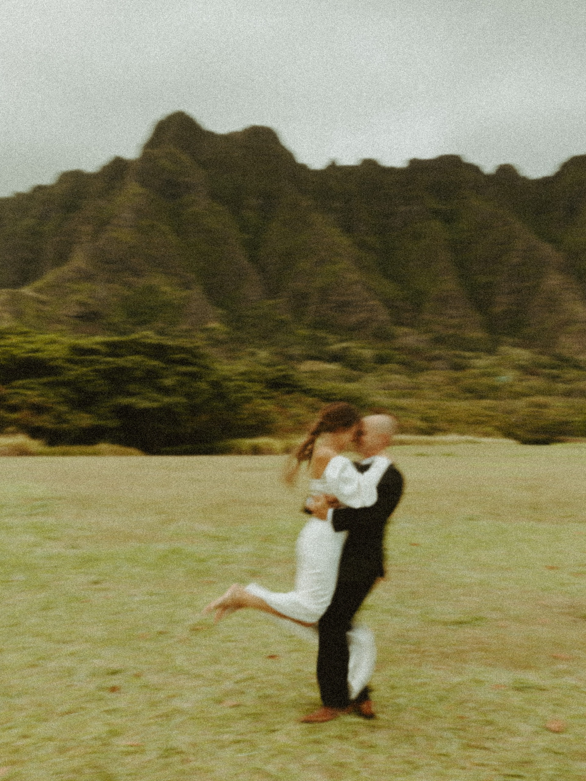 the couple dancing around at Kualoa Ranch in Oahu Hawaii