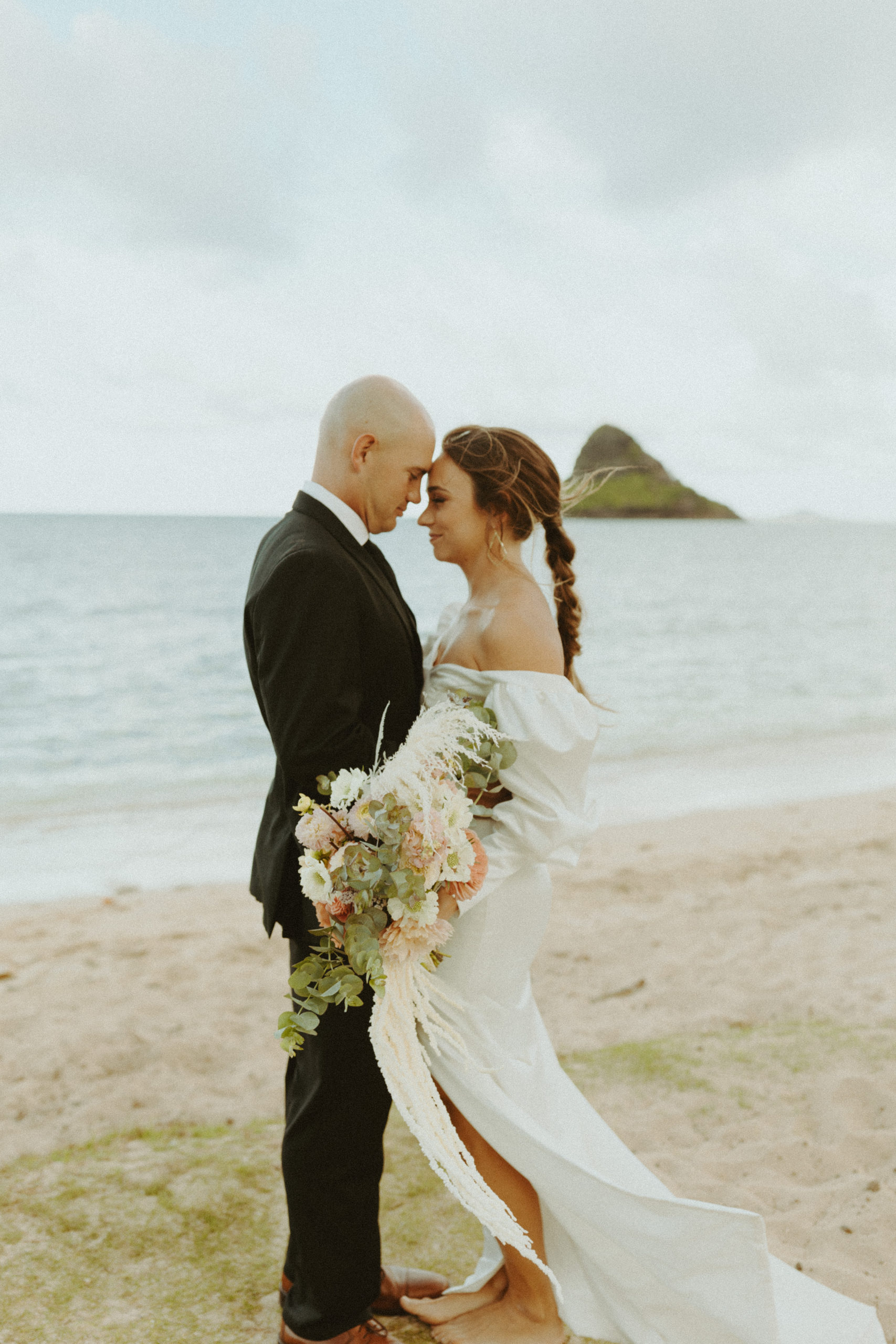 the couple looking into one another's eyes at the Kualoa Ranch in Oahu