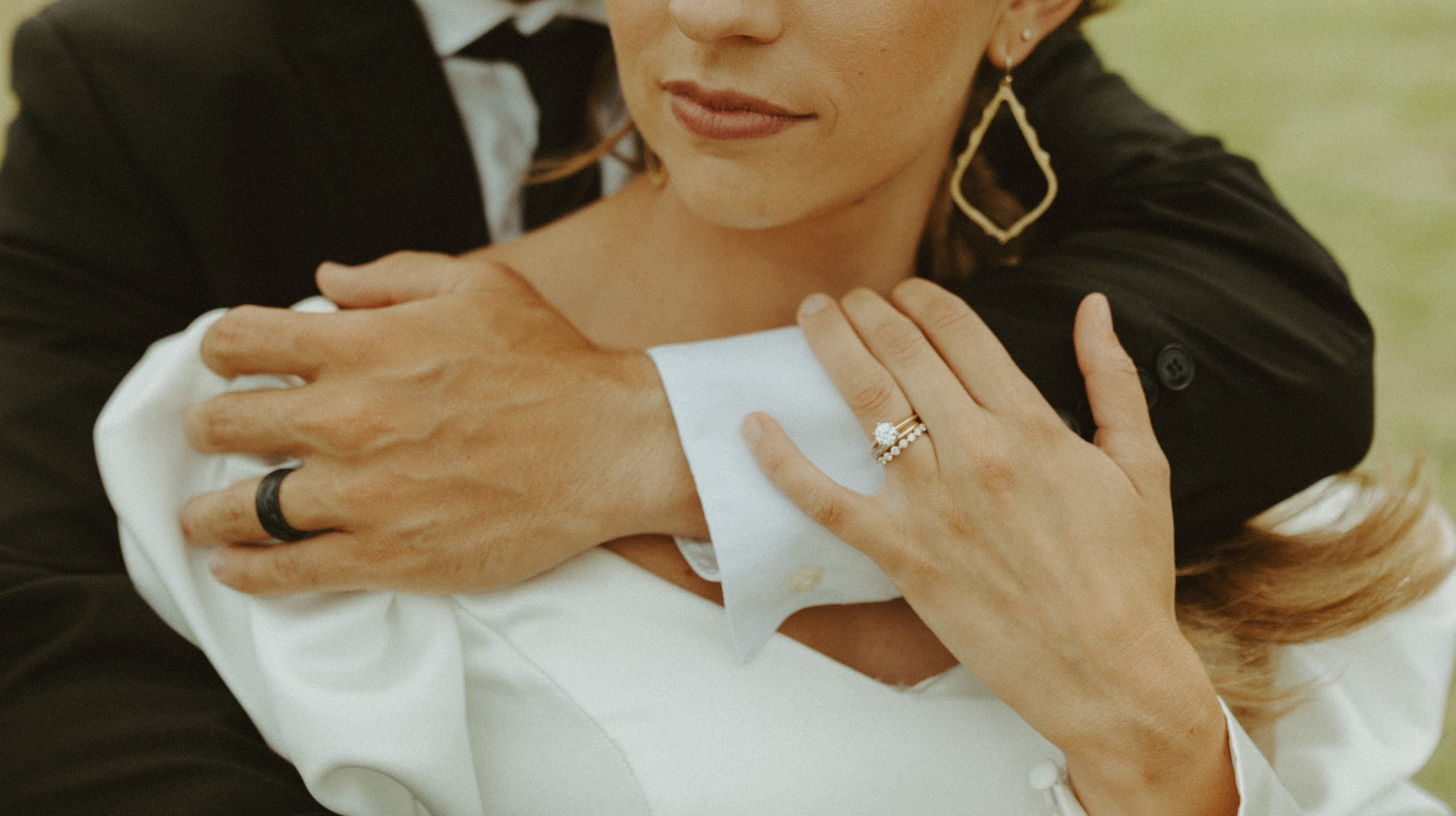 the arms of the couple showing off their wedding rings
