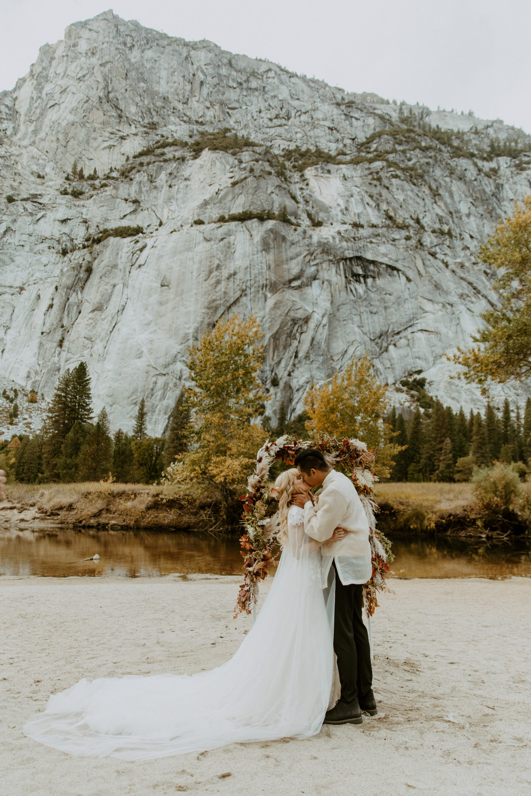 the bride and groom kissing at Yosemite