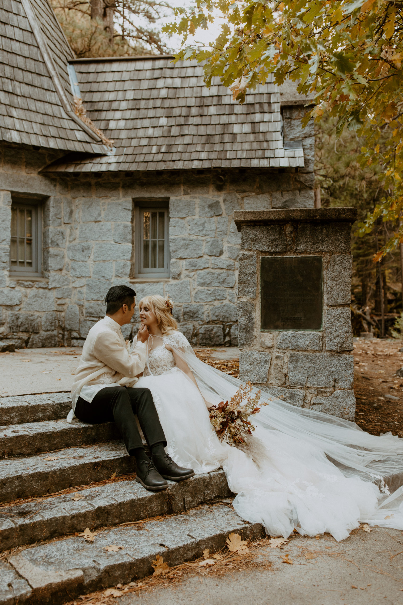 the couple sitting on the steps of their elopement venue
