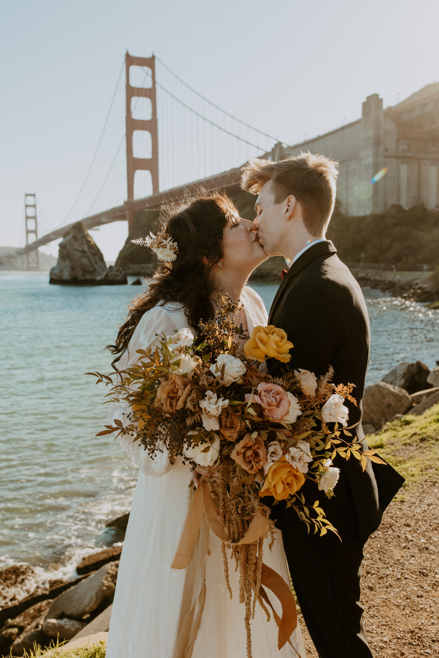 the couple kissing at the Golden Gate Bridge at their Cavallo Point Wedding