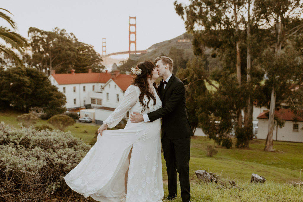 the couple kissing as she twirls her dress at the Cavallo Point Wedding
