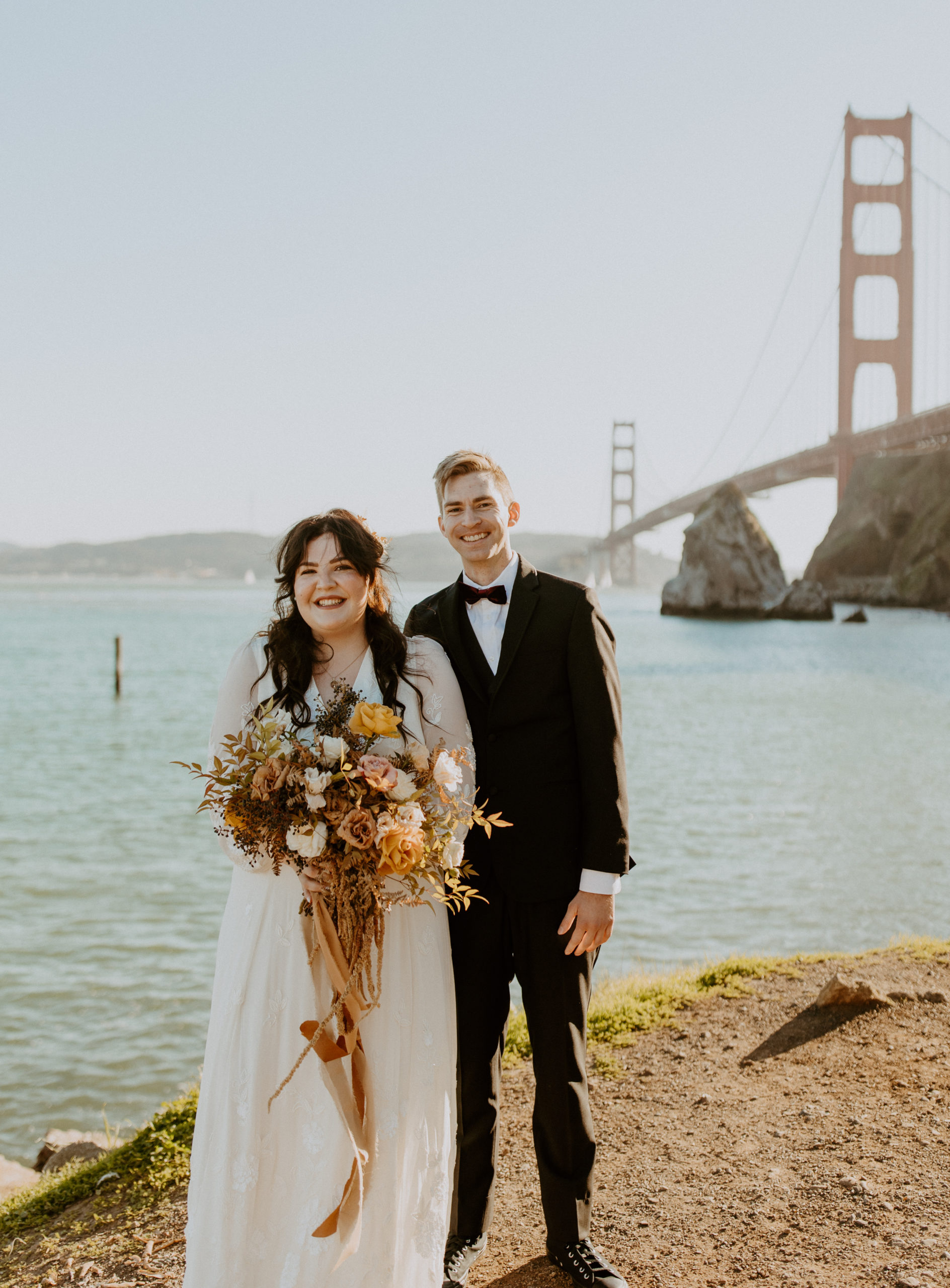 the couple standing next to the Golden Gate Bridge