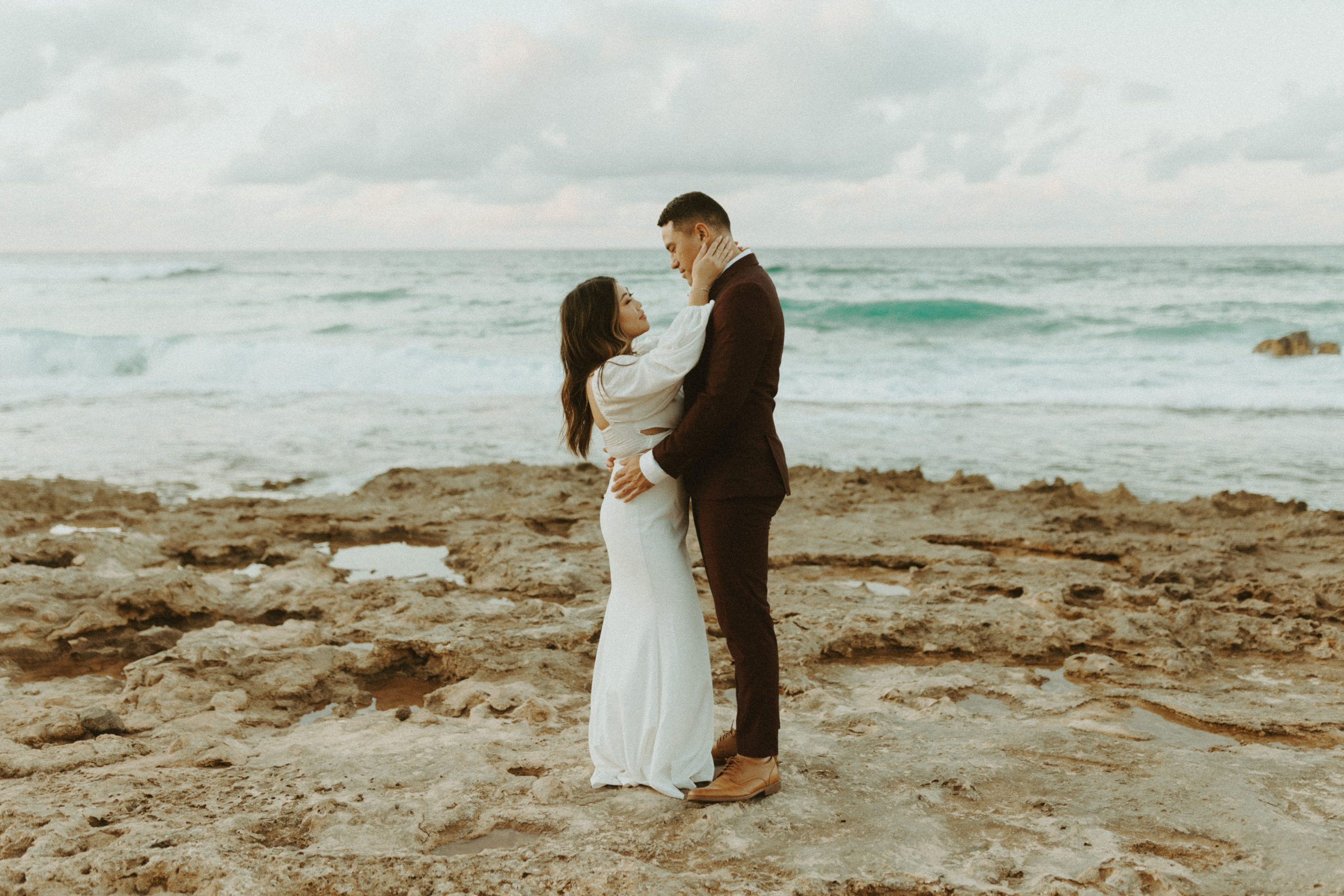 the couple standing next to each other as they stand by the water
