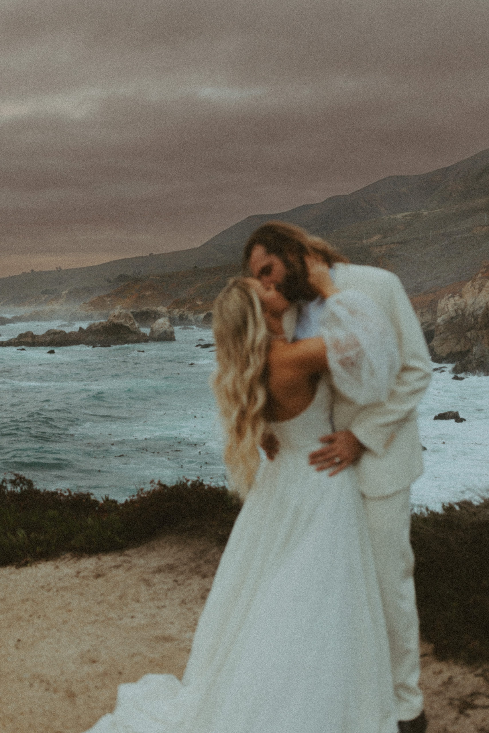 the bride and groom kissing during sunset at Big Sur California