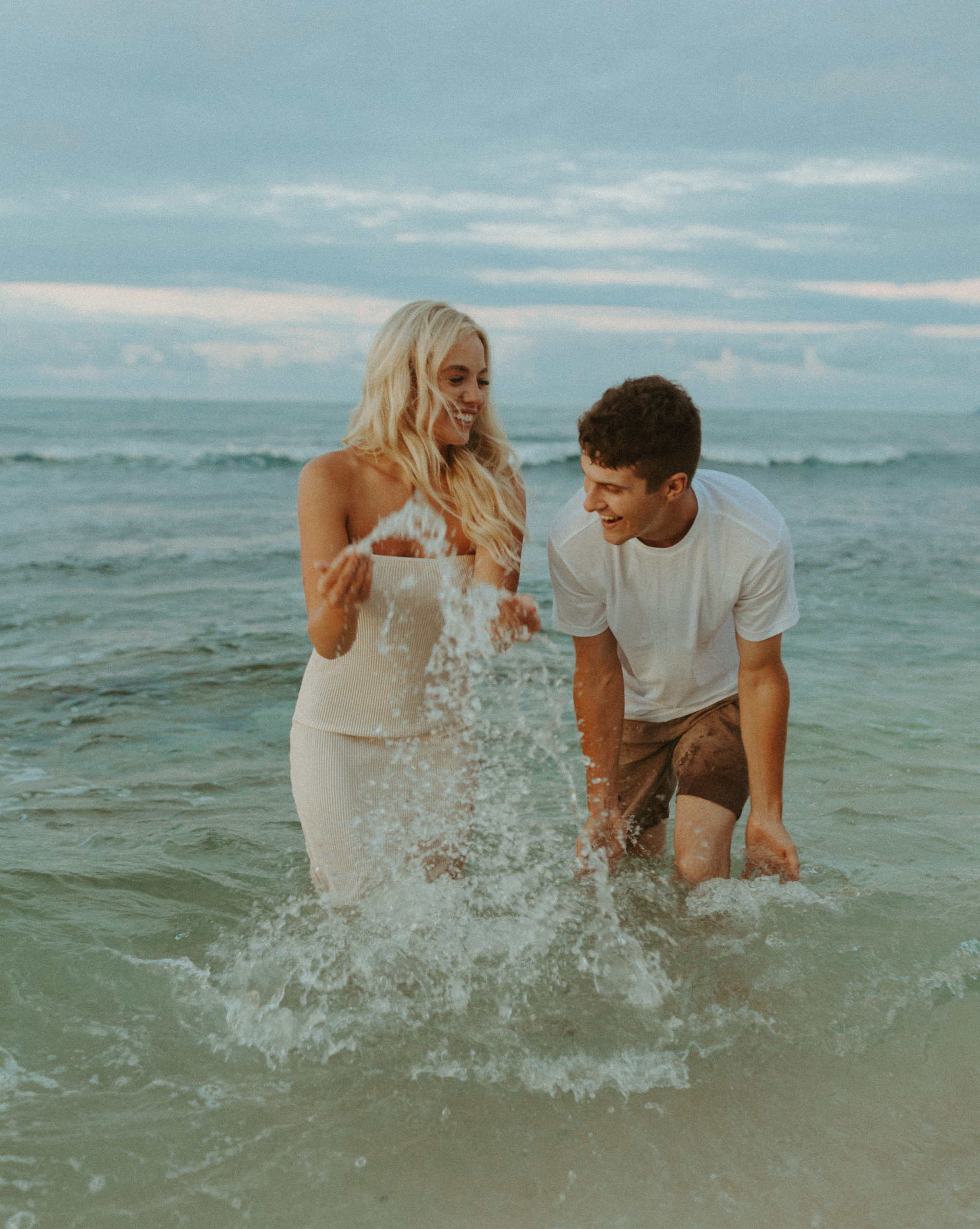 the couple splashing in the water