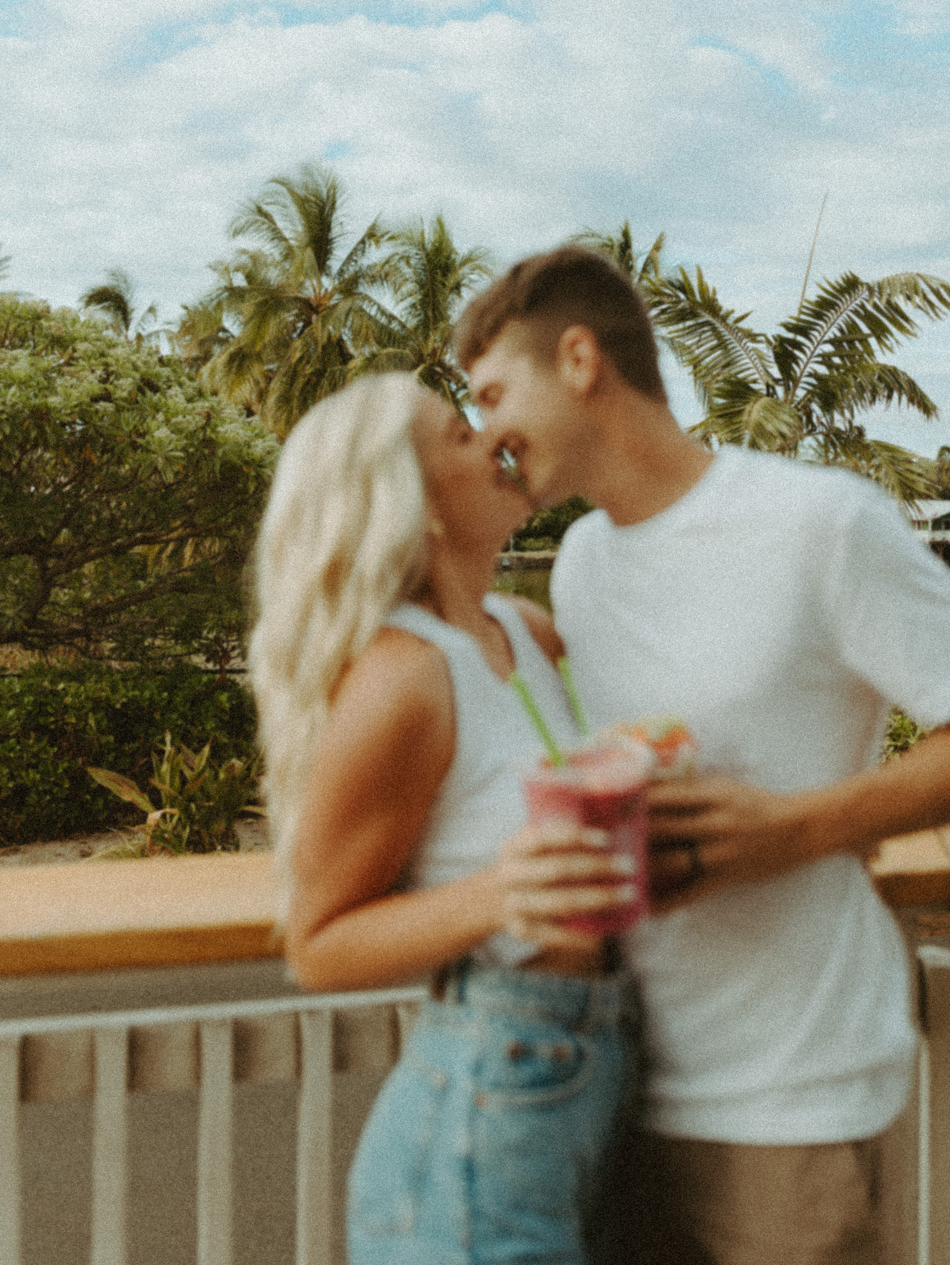 the couple leaning in to kiss at the smoothie bowls