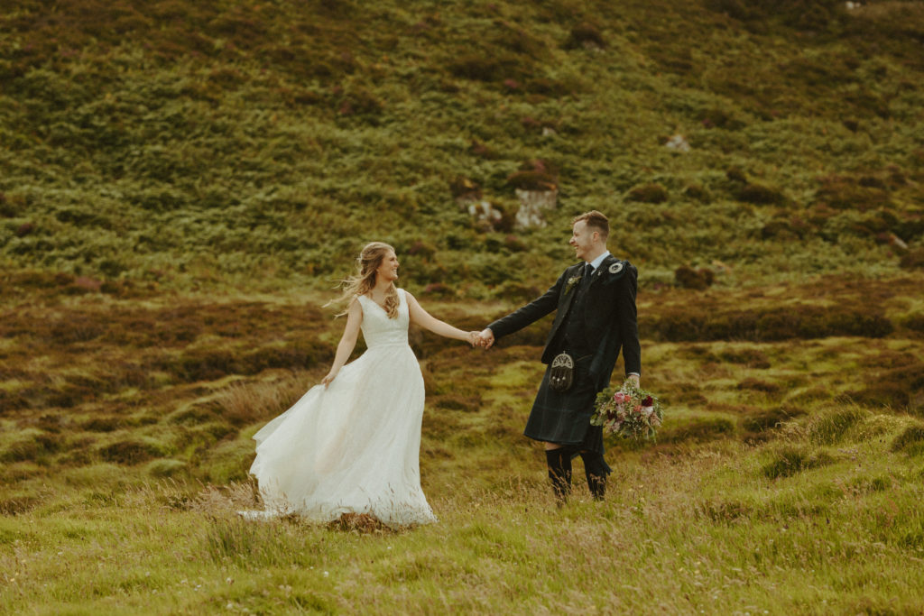 the couple holding hands in Scotland