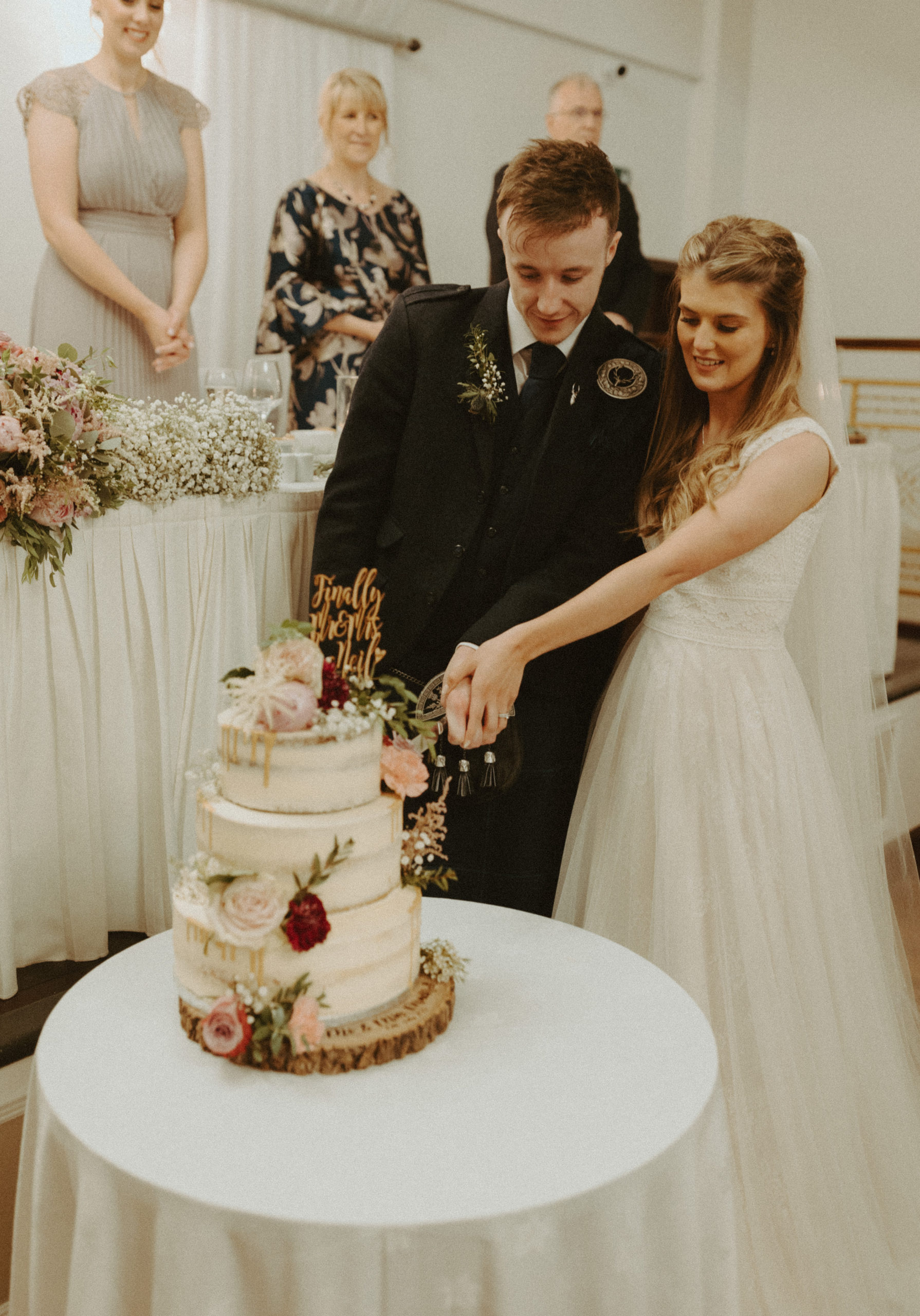 the wedding couple cutting the wedding cake