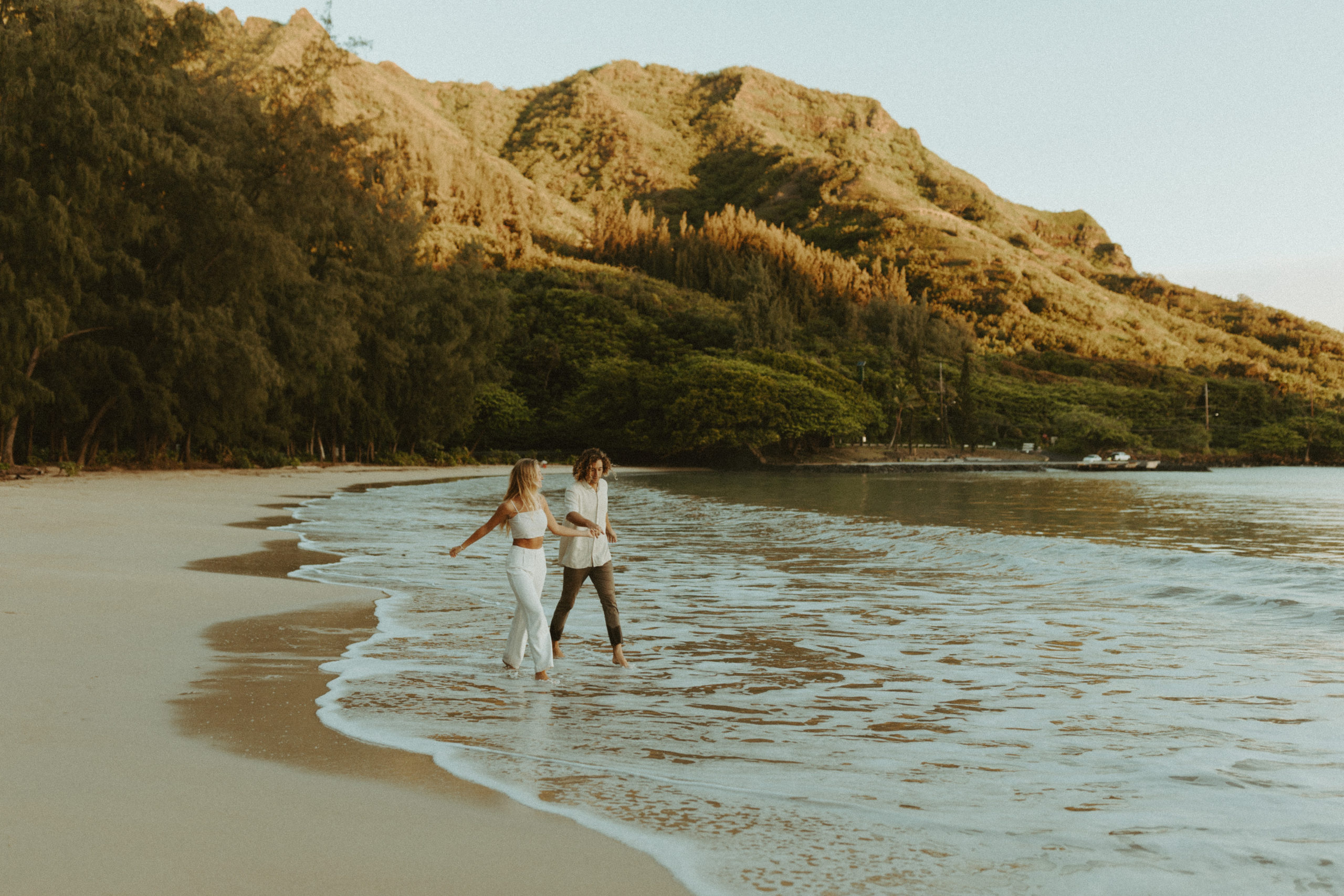 the couple running through the water in Hawaii