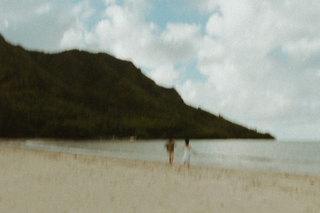 the beach for their Hawaii engagement photos