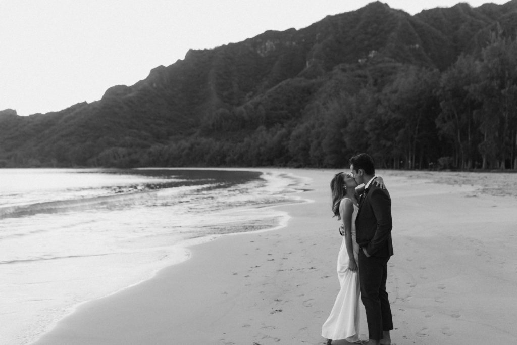 the couple kissing on the beach during their content day in Hawaii