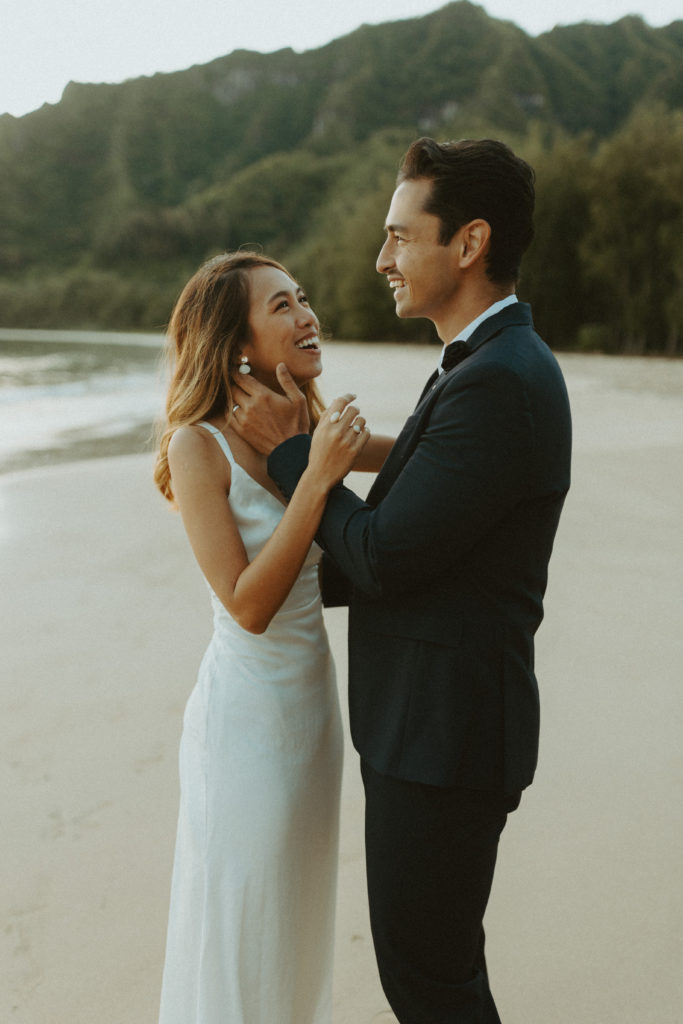 the couple laughing at one another as the Hawaii photographer captures them
