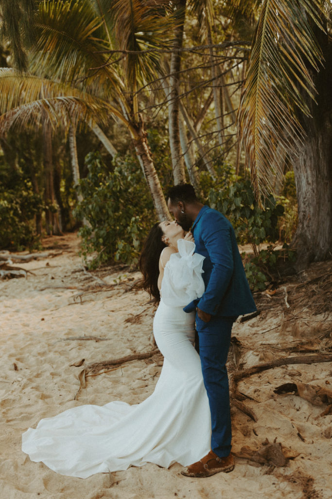 the elopement couple kissing at the beach in Hawaii