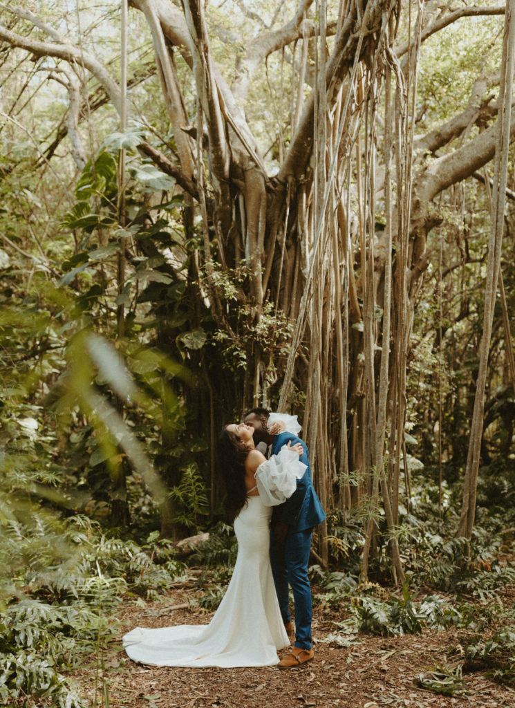 the groom kissing the bride in Hawaii