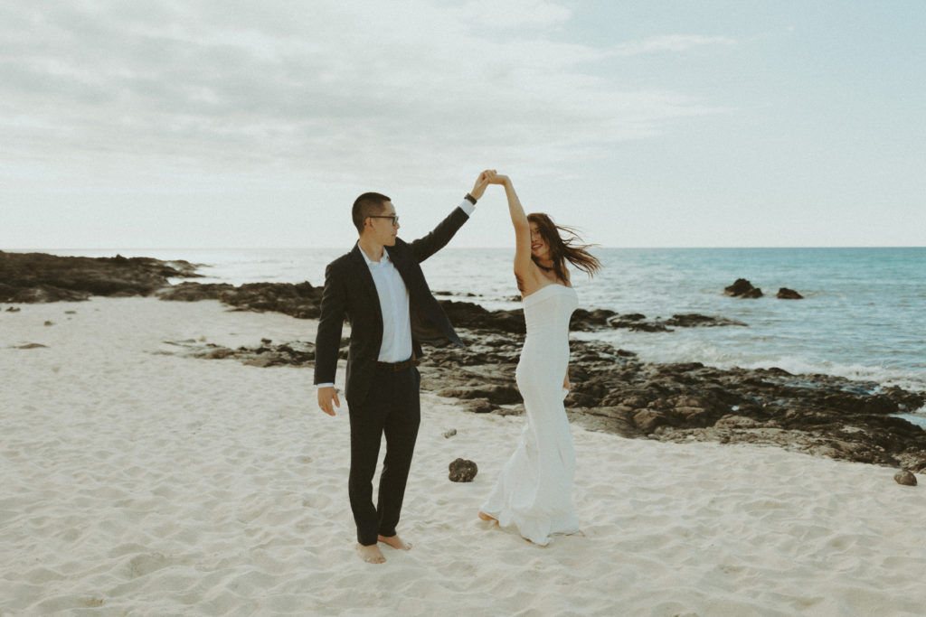 the couple twirling on the beach for their Big Island Kona Wedding