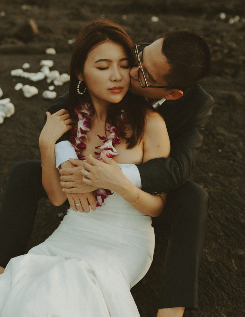 the groom kissing the bride's cheek in Hawaii 