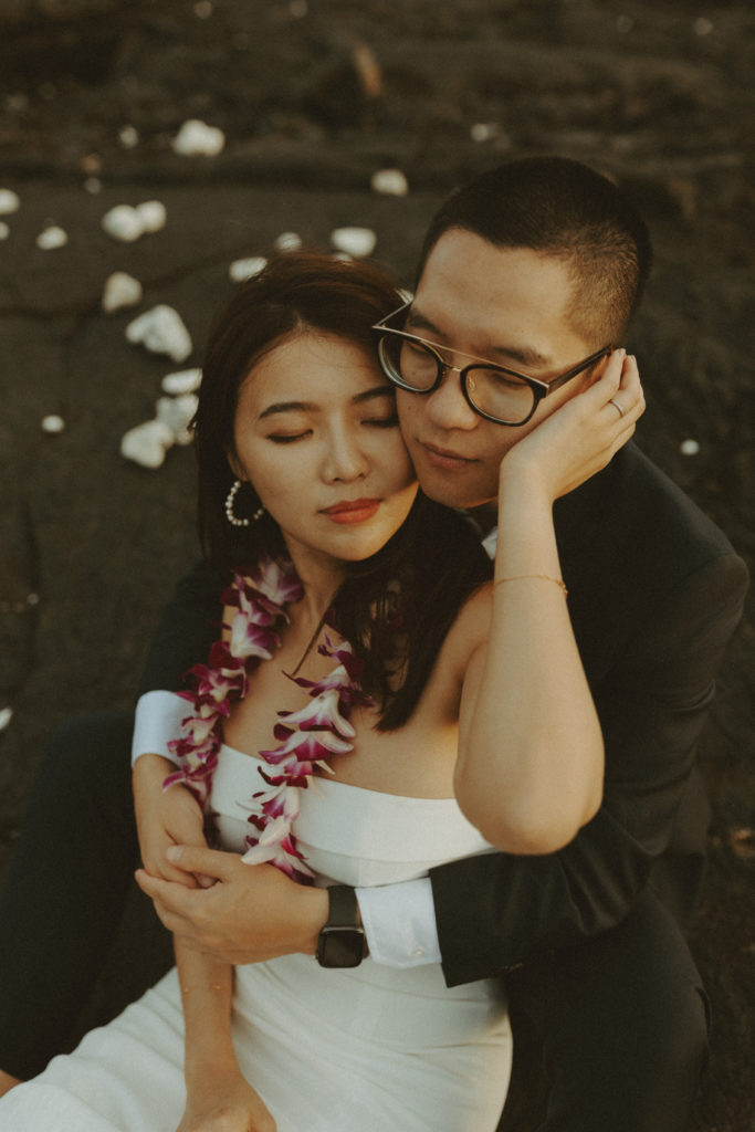 the couple sitting together during their elopement in Hawaii