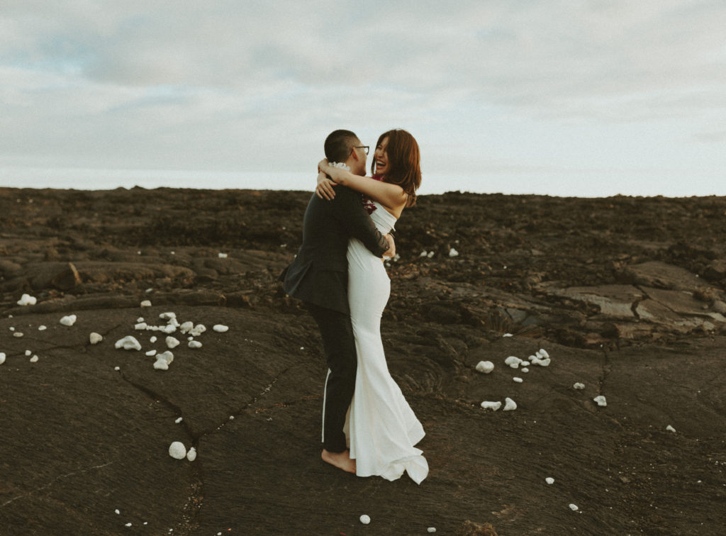 the couple smiling at one another during their Hawaii wedding photos