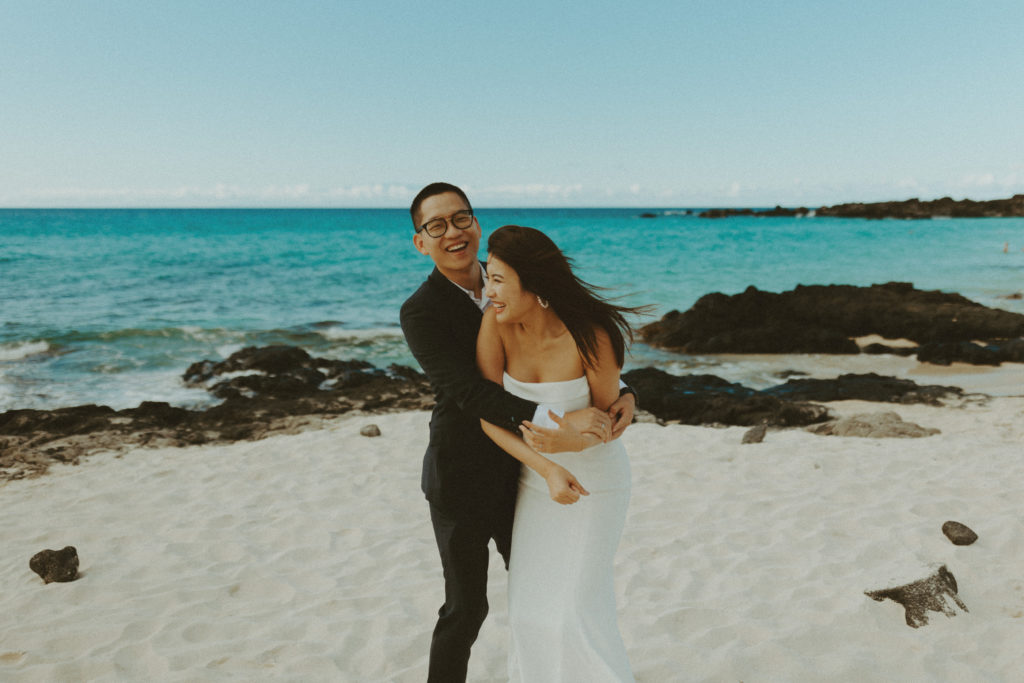 the couple laughing together during their Hawaii wedding