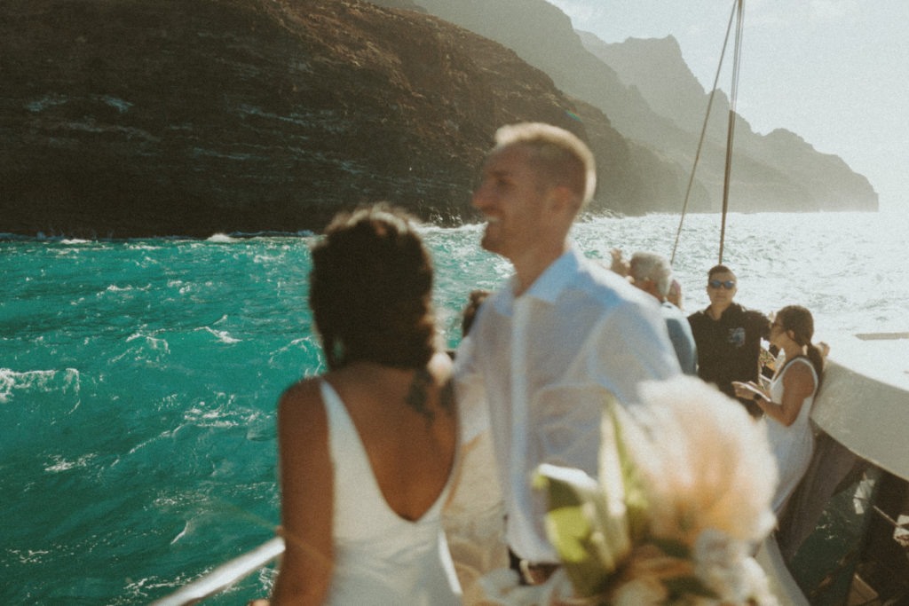 the couple laughing on the boat together during their Kauai elopement
