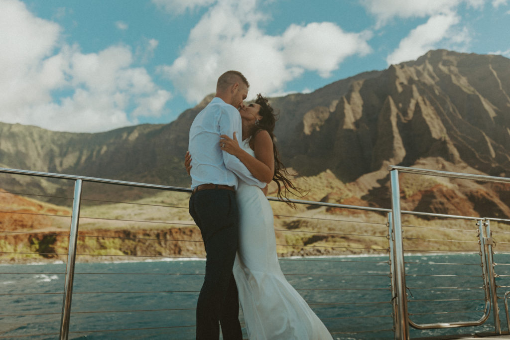 the couple looking at one another on their boat during their Kauai elopement
