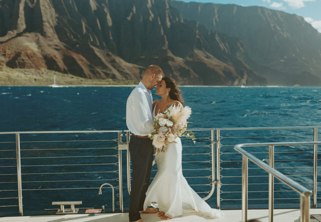 the wedding couple posing for the wedding photographer in Hawaii on the boat