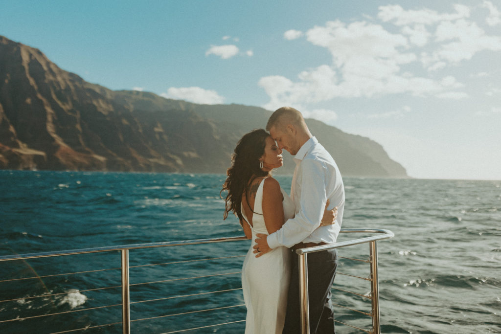 the couple posing together on the boat during their Kauai elopement in Hawaii