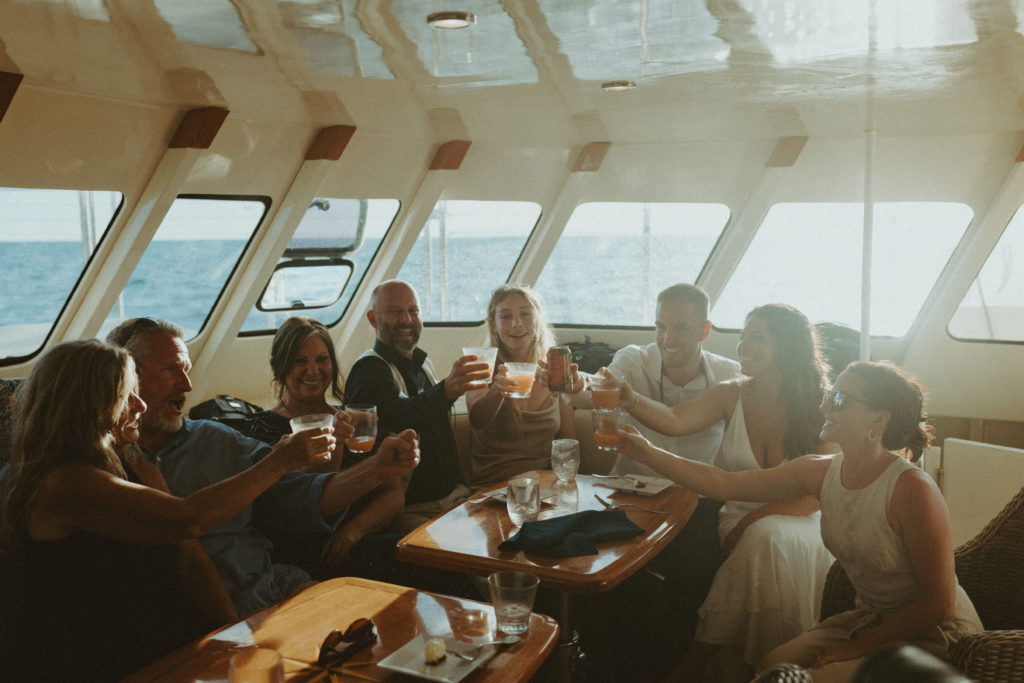 the wedding guests on the boat in Hawaii to celebrate the elopement