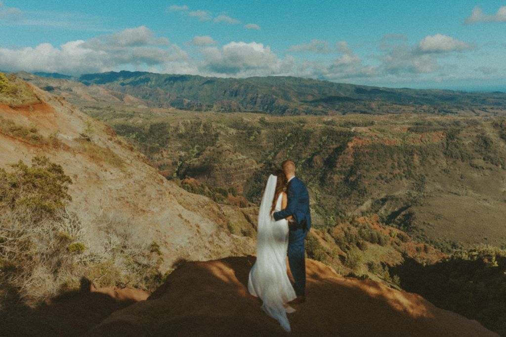 the couple looking out over the edge of the canyon for their elopement