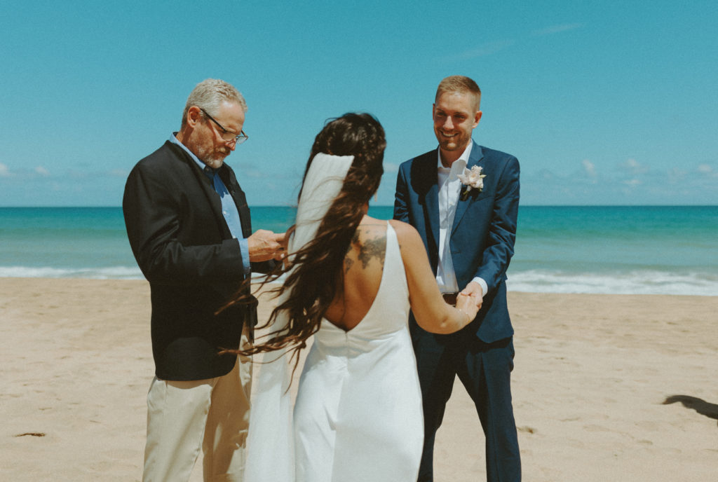 the couple at their beach ceremony for their Kauai elopement