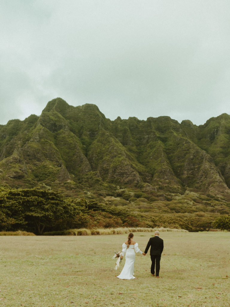 the wedding couple walking away from the wedding photographer in Hawaii 