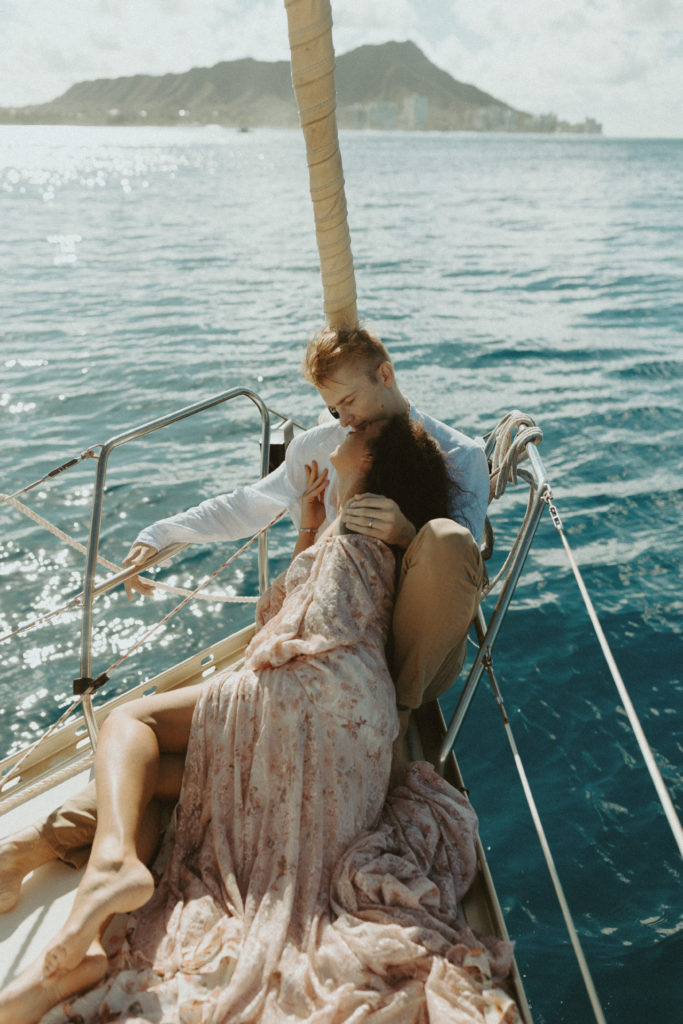 the couple relaxing on the sailboat for their couple photoshoot