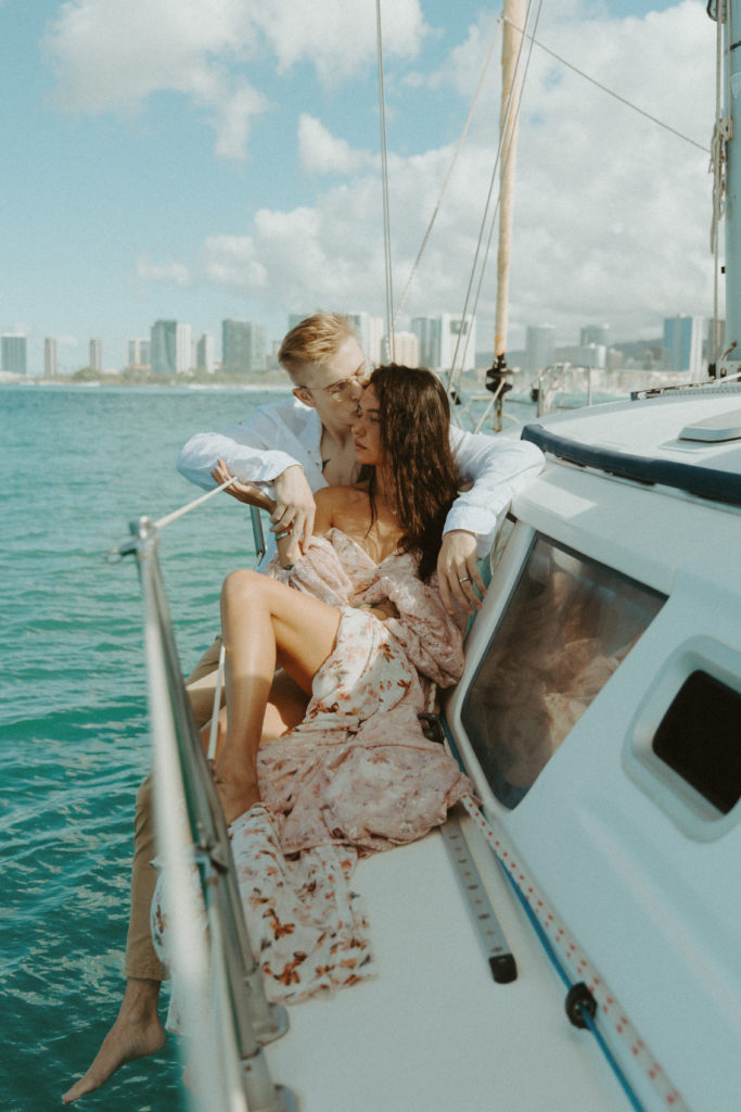 the couple sitting on the boat together during their couples photoshoot