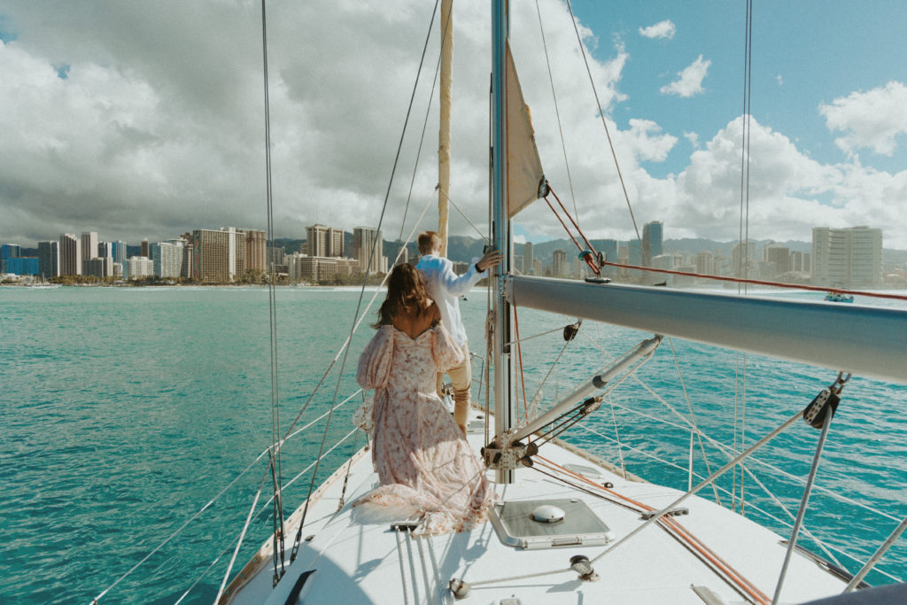 the couple walking on the sailboat during their couple photos