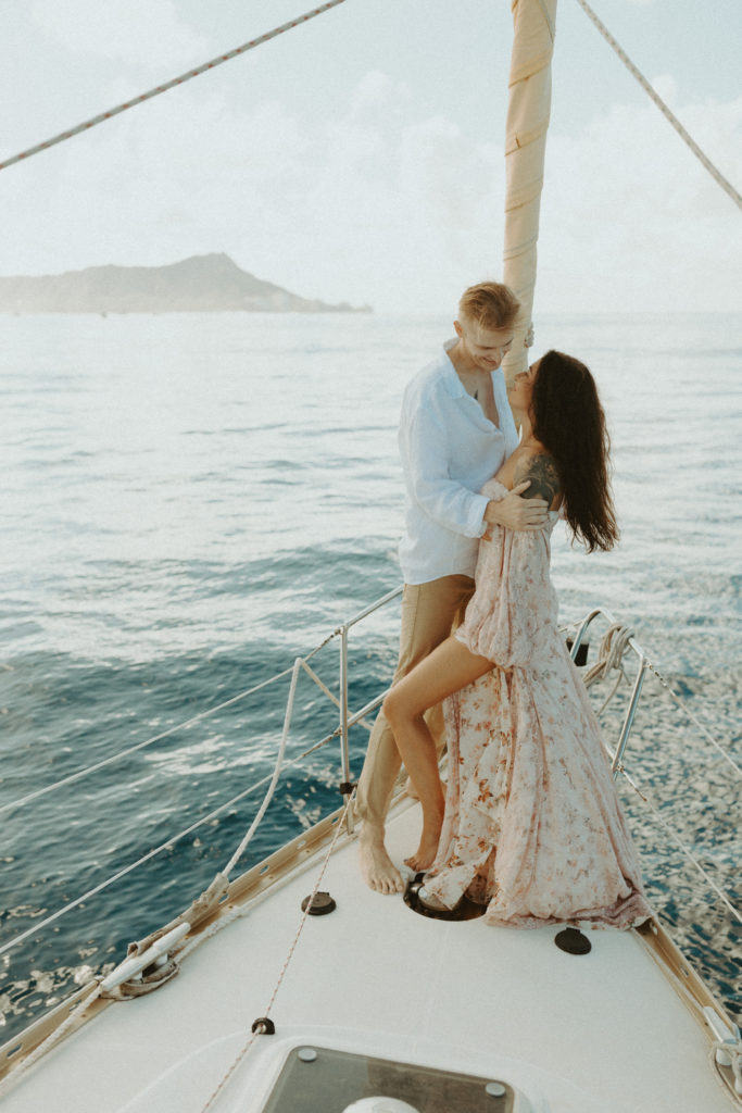 the couple looking into each other's eyes on the sailboat