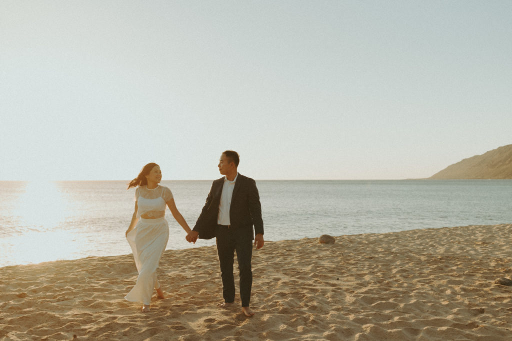 bride and groom posing on a beach after for their bridal portraits