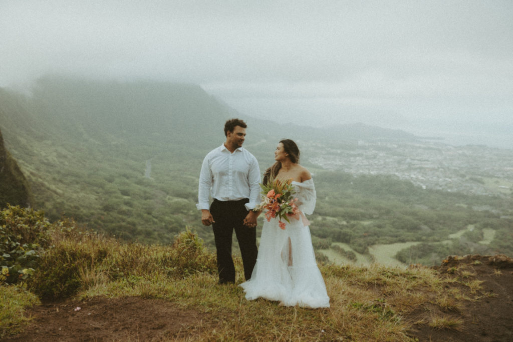 couple posing for wedding photos on a mountain
