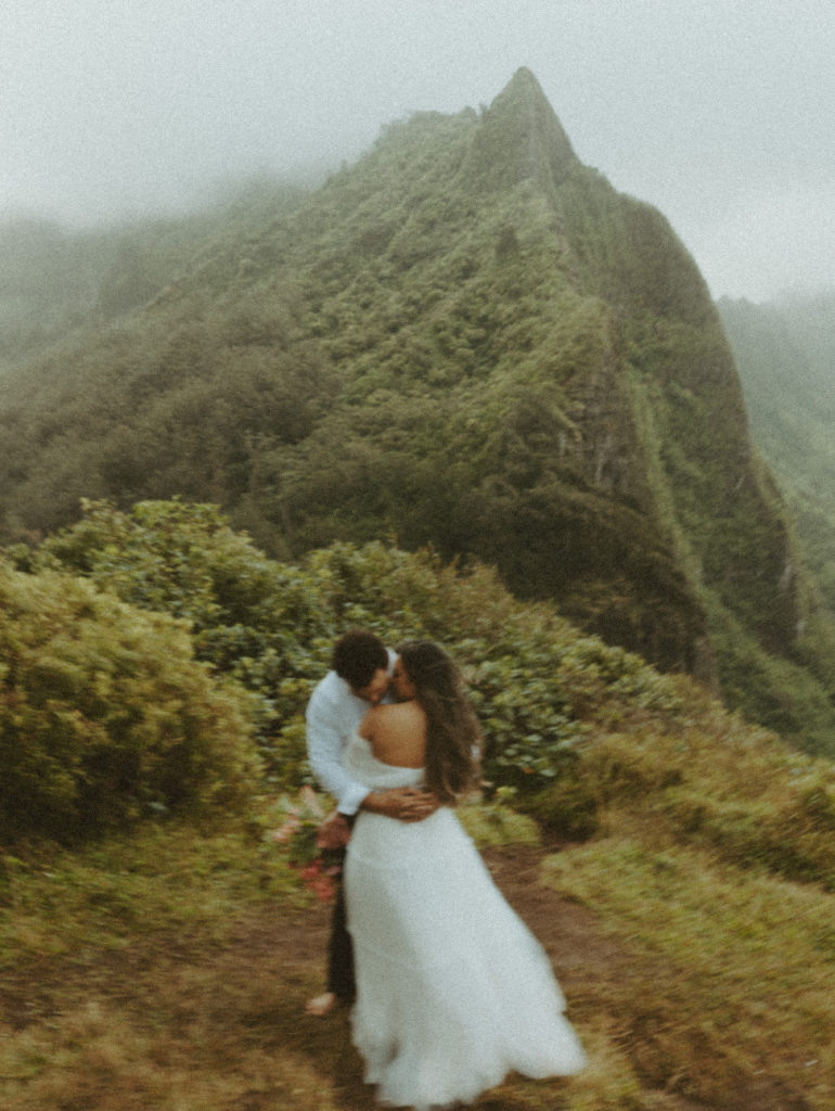 couple posing for wedding photos on a mountain